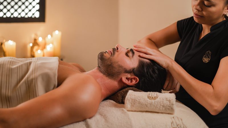 man receiving a scalp massage
